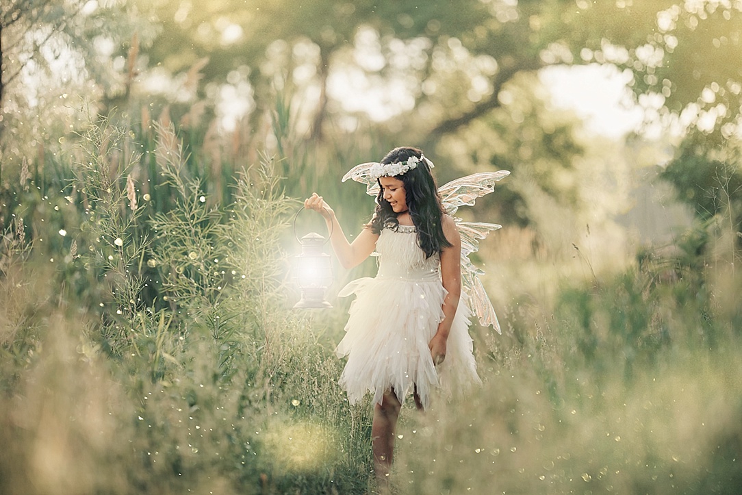 Fairy girl holding lantern in magical forest.
