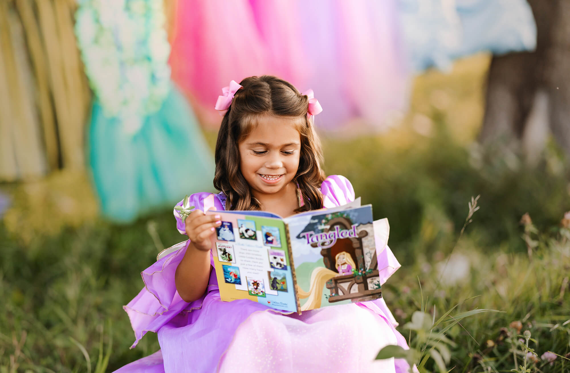 Girl in purple dress reading Tangled book.
