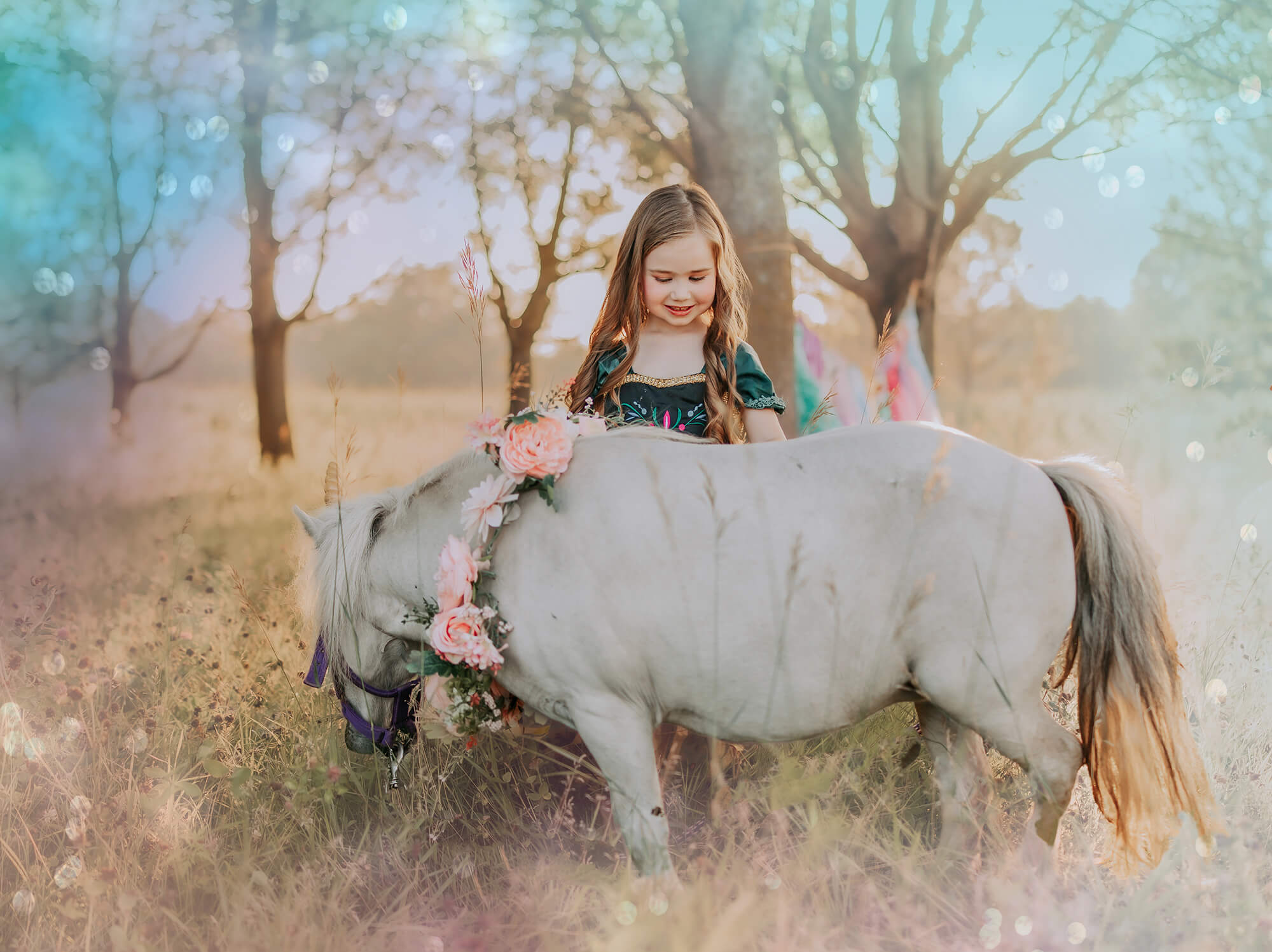 Girl with pony in flower-adorned field